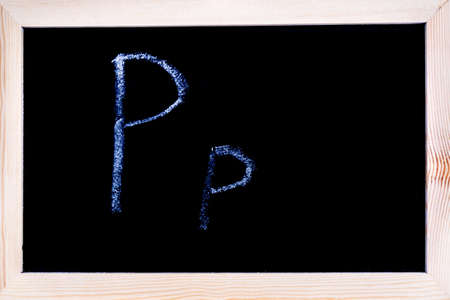 Blackboard with white chalk writing showing capital and lowercase Pの写真素材