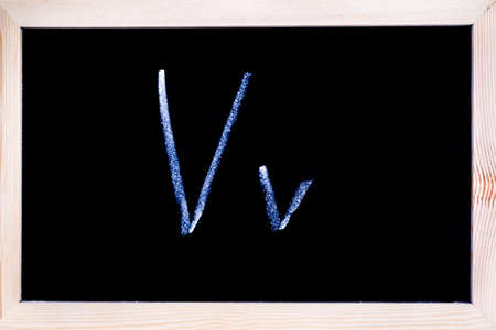 Blackboard with white chalk writing showing capital and lowercase Vの写真素材