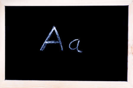 Blackboard with white chalk writing showing capital and lowercase Aの写真素材
