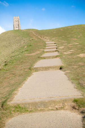 Glastonbury Tor in Somerset, United Kingdom, with the ruins of St Michael's Church demolished in 1539 during the Dissolution of the Monasteriesの写真素材