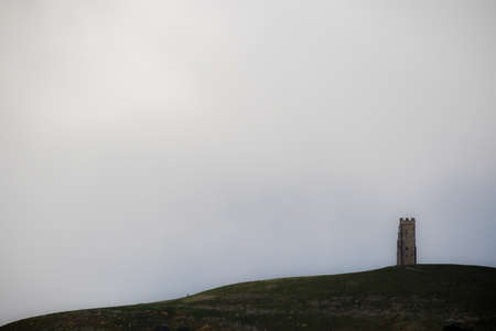 Glastonbury Tor in Somerset, United Kingdom, with the ruins of St Michael's Church demolished in 1539 during the Dissolution of the Monasteriesの写真素材