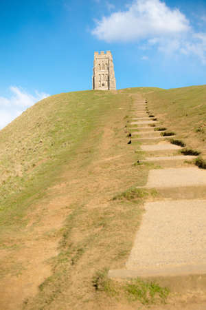 Glastonbury Tor in Somerset, United Kingdom, with the ruins of St Michael's Church demolished in 1539 during the Dissolution of the Monasteriesの写真素材
