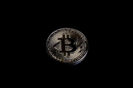 A bitcoin concept with tokens on a black background to represent the dark use of the currencyの写真素材
