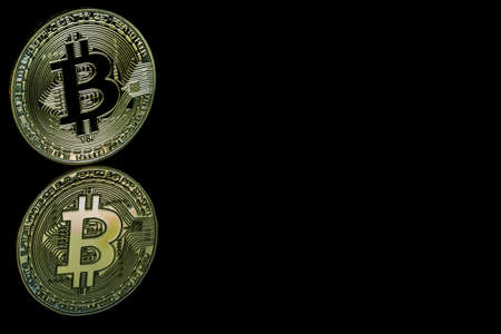 A bitcoin concept with tokens on a black background to represent the dark use of the currencyの写真素材