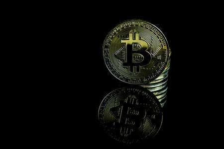 A bitcoin concept with tokens on a black background to represent the dark use of the currencyの写真素材