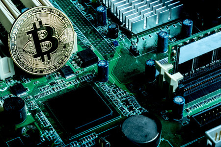 A bitcoin concept with tokens on a computer circuit board showing the currency is virtual