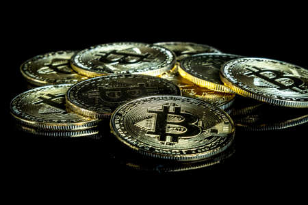 A bitcoin concept with tokens on a black background to represent the dark use of the currencyの写真素材