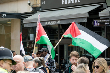 London, United Kingdom, 14th April 2018:- Protesters gather along Kensington High Street, near the...