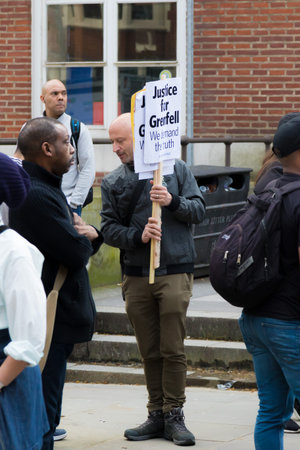 London, United Kingdom, 14th April 2018:- Marchers on a silent march from Kensington Town Hall to...