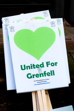 London, United Kingdom, 14th April 2018:- Banners ready for a silent march from Kensington Town Hall to the ruins of Grenfell tower ten months on from the devastating fire that killed 71のeditorial素材