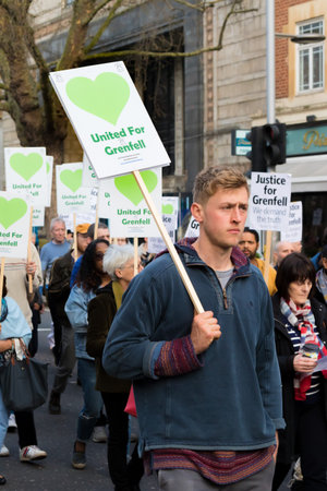 London, United Kingdom, 14th April 2018:- Marchers on a silent march from Kensington Town Hall to...