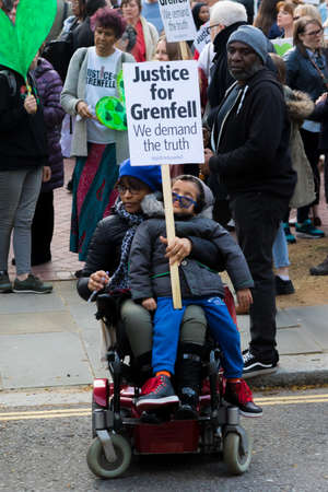 London, United Kingdom, 14th April 2018:- Marchers on a silent march from Kensington Town Hall to the ruins of Grenfell tower ten months on from the devastating fire that killed 71のeditorial素材