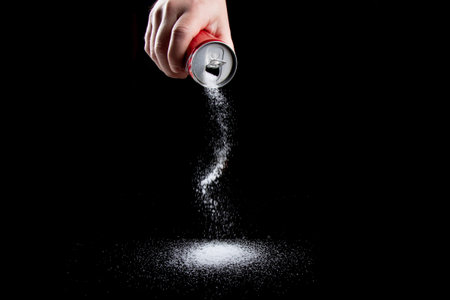 Healthcare concept with sugar pouring from a drinks can