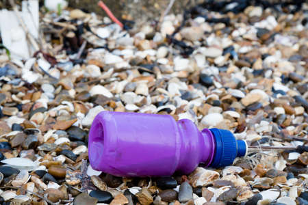 Plastic litter and other rubbish left on the beach on the Isle of Grain, Kent, United Kingdomの写真素材