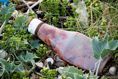 Plastic litter and other rubbish left on the beach on the Isle of Grain, Kent, United Kingdomの写真素材
