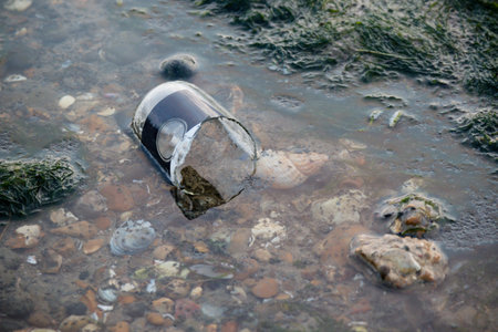Plastic litter and other rubbish left on the beach on the Isle of Grain, Kent, United Kingdom
