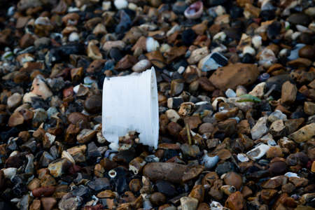 Plastic litter and other rubbish left on the beach on the Isle of Grain, Kent, United Kingdomの写真素材