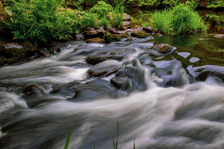 Long exposure of fast moving water in Dartmoor National Parkの写真素材