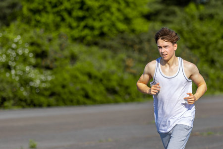Young male caucasian adult jogging outside on a warm summer's day