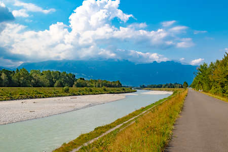 A view of the river Rhine across the international border between Liechtenstein and Swizerlandの写真素材