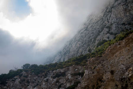 Clouds form on the East side of the Rock of Gibraltar. Gibraltar is a British Overseas Territory located on the southern tip of Spain.の写真素材