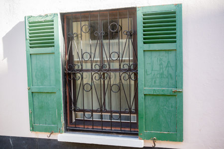 Open shuttered windows in Gibraltar. Gibraltar is a British Overseas Territory located on the...