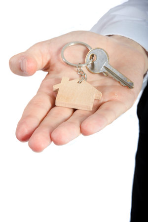 Young adult wearing office attire holding house keys