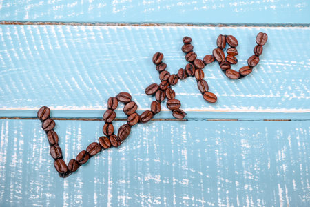 Latte spelt out with coffee beans on a wooden background