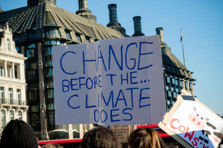 London, UK, United Kingdom 15th February 2019:- Striking school aged children in central London over climate change holding a placardのeditorial素材