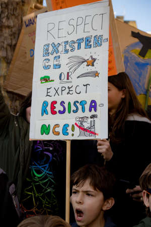 London, UK, United Kingdom 15th February 2019:- Striking school aged children in central London over climate change holding a placardのeditorial素材