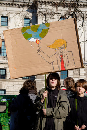 London, UK, United Kingdom 15th February 2019:- Striking school aged children in central London over climate change holding a placardのeditorial素材