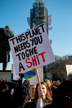 London, UK, United Kingdom 15th February 2019:- Striking school aged children in central London over climate change holding a placardのeditorial素材