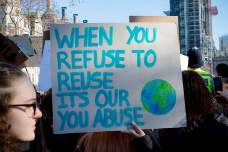 London, UK, United Kingdom 15th February 2019:- Striking school aged children in central London over climate change holding a placardのeditorial素材