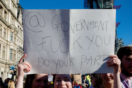 London, UK, United Kingdom 15th February 2019:- Striking school aged children in central London over climate change holding a placardのeditorial素材