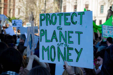 London, UK, United Kingdom 15th February 2019:- Striking school aged children in central London over climate change holding a placardのeditorial素材