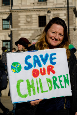 London, UK, United Kingdom 15th February 2019:- An adult in support of striking school aged children...