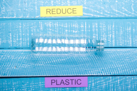 Recycle concept showing plastic & reduce  on a blue weathered background