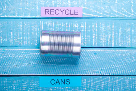 Recycle concept showing cans and recycle on a blue weathered backgroundの写真素材