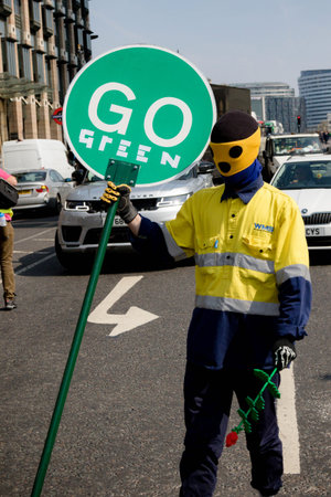 London, United Kingdom, 15th April 2019:- Extinction Rebellion protester blocking traffic near...