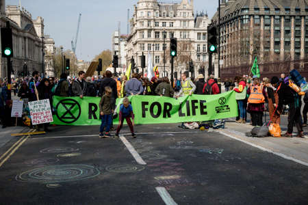London, United Kingdom, 15th April 2019:- Extinction Rebellion child protester in Parliament Square, plays hop scotch protesting about climate change.のeditorial素材