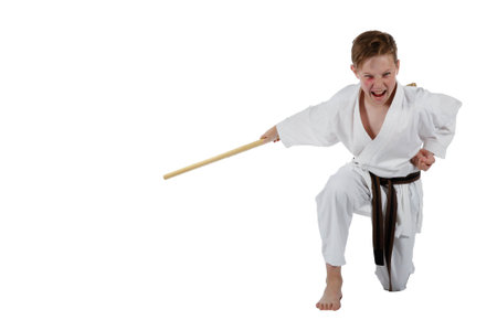 Teenage caucasian boy wearing a karate uniform using a boの写真素材