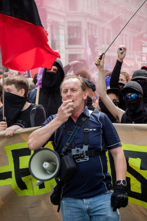 London, United Kingdom, August 3rd 2019:- A protester with a megaphone counter protesting a rally by...