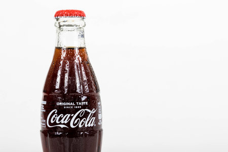 London, United Kingdom, 16th August 2019:- A cold Coca-Cola glass bottle. Contains 10.6g of sugar...