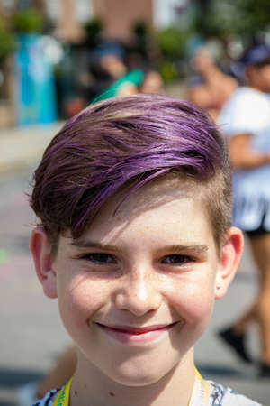 London, United Kingdom, August 25th 2019:-A young reveller with purple hair at the Notting Hill Carnival in West London, the Notting Hill Carnival is Europe's largest street party.のeditorial素材