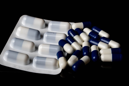 Illegal drug crisis concept showing tablets on a black background