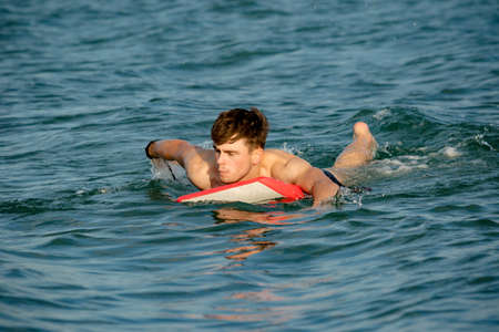 Young adult caucasian male body boarding on a summerâs afternoonの写真素材