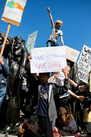 London, United Kingdom, 20th September 2019:- Climate Change Protesters gather in Westminster, a young boy climbs a statue outside parliamentのeditorial素材