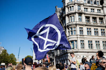 London, United Kingdom, 20th September 2019:- Climate Change Protesters gather in Westminster, fly the flag of Extinction Rebellionのeditorial素材