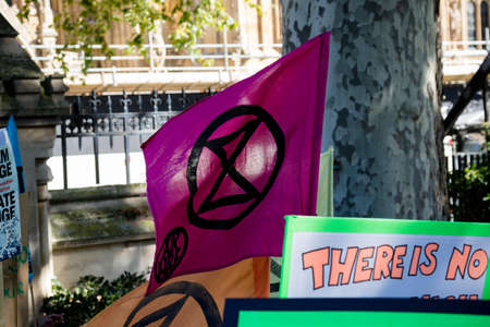 London, United Kingdom, 20th September 2019:- Climate Change Protesters gather in Westminster, fly the flag of Extinction Rebellionのeditorial素材