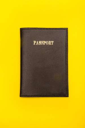 Travel concept showing a passport on a yellow background